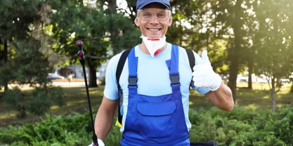 pest control tech in a blue outfit