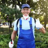pest control tech in a blue outfit